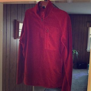Red quarter zip sweater.